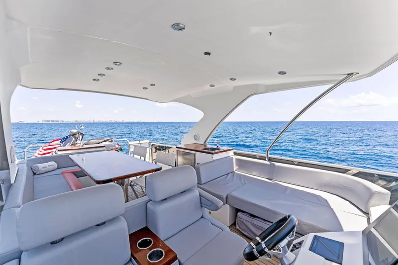 Slide: The Image of Luxurious 2014 Lazzara 64 yacht interior with ocean view, featuring elegant seating and modern amenities. - 33