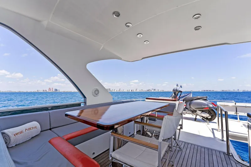 Slide: The Image of Luxurious 2014 Lazzara 64 yacht deck with seating, table, and ocean view. - 36