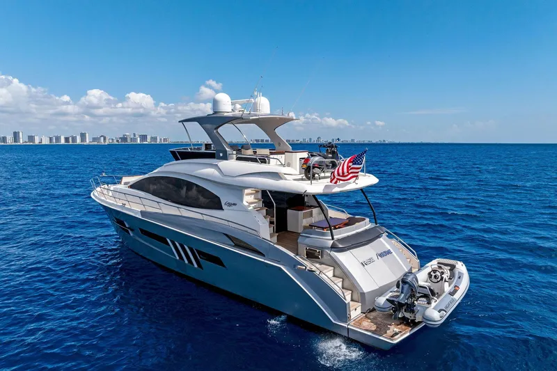 Slide: The Image of 2014 Lazzara 64 yacht cruising on blue ocean with city skyline in background. - 4