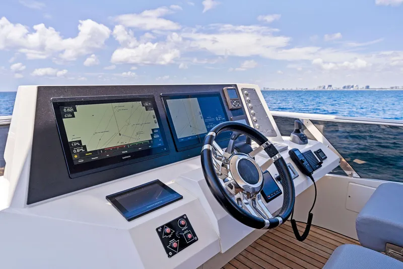 Slide: The Image of Cockpit of 2014 Lazzara 64 yacht with navigation screens and steering wheel, ocean view. - 40