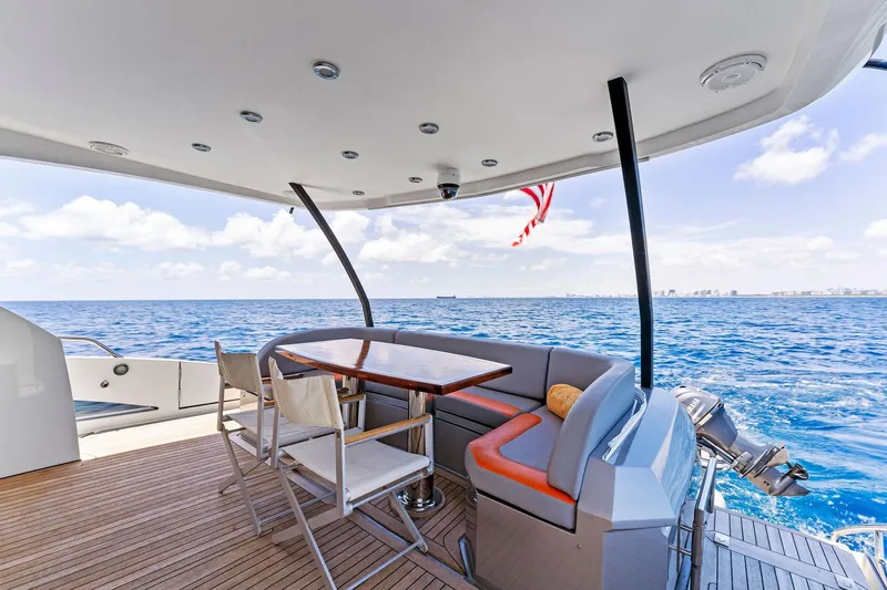 Slide: The Image of Luxurious 2014 Lazzara 64 yacht deck with seating, ocean view, and American flag. - 41