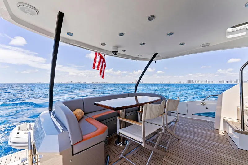 Slide: The Image of Luxurious 2014 Lazzara 64 yacht deck with seating, table, and ocean view. - 42
