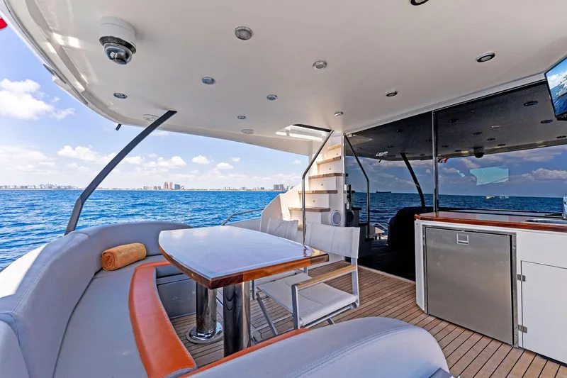 Slide: The Image of Luxurious 2014 Lazzara 64 yacht deck with seating, table, and ocean view. - 43