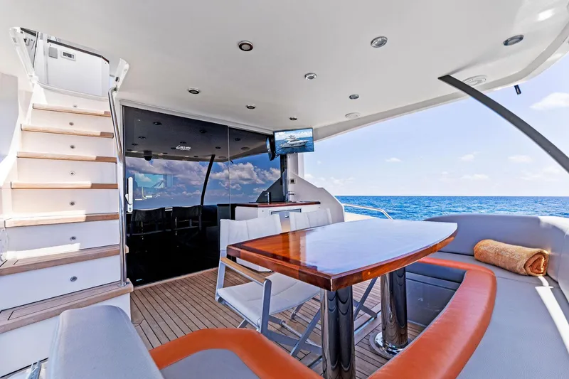 Slide: The Image of Luxurious 2014 Lazzara 64 yacht deck with seating, table, and ocean view. - 44