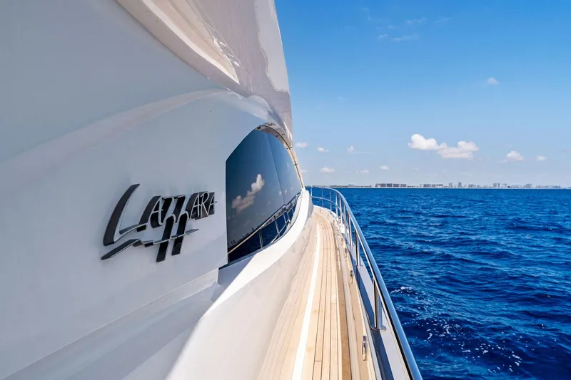 Slide: The Image of 2014 Lazzara 64 yacht cruising on open blue sea under clear sky. - 47