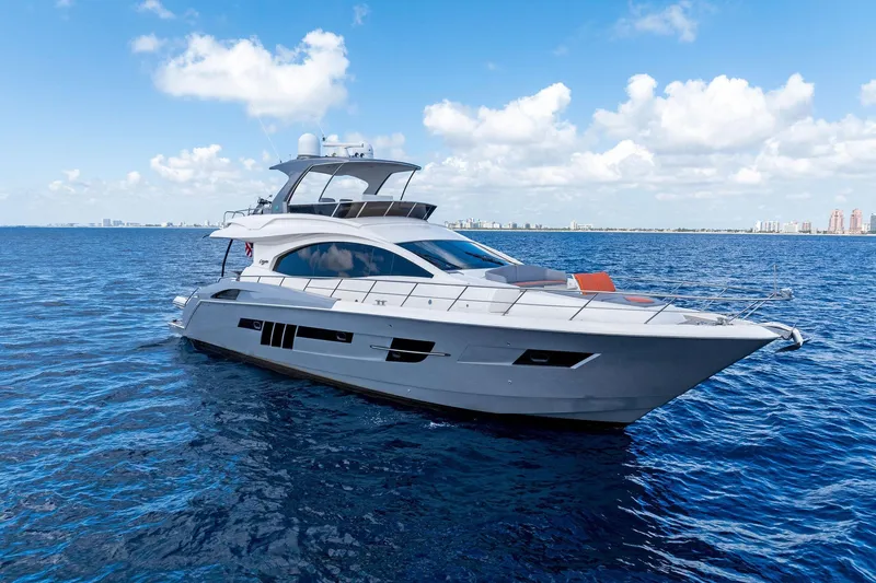 Slide: The Image of Luxurious 2014 Lazzara 64 yacht cruising on open blue waters under a clear sky. - 5