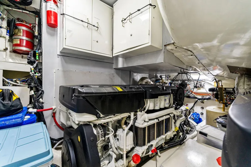 Slide: The Image of Engine room of a 2014 Lazzara 64 yacht, featuring organized equipment and storage. - 66
