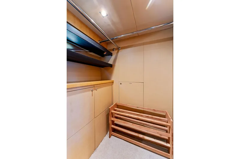 Slide: The Image of Interior storage space on a 2014 Lazzara 64 yacht with wooden shelves and cabinets. - 72