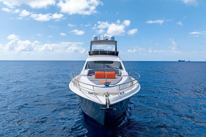 Slide: The Image of 2014 Lazzara 64 yacht on open sea under clear blue sky. - 73