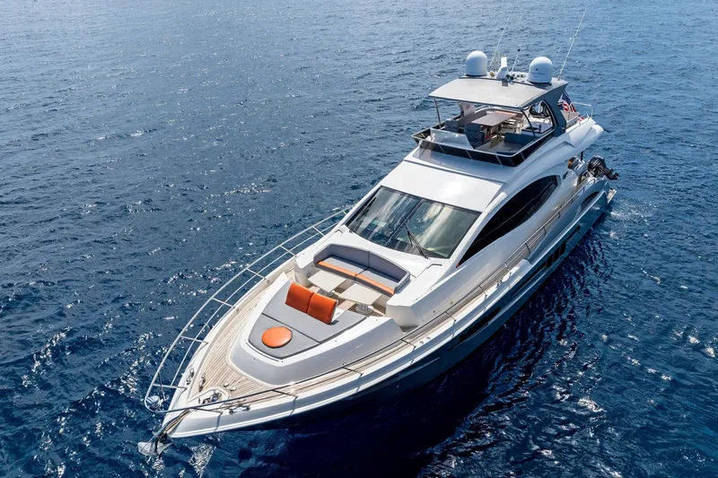 Slide: The Image of Luxurious 2014 Lazzara 64 yacht cruising on open blue waters. - 74