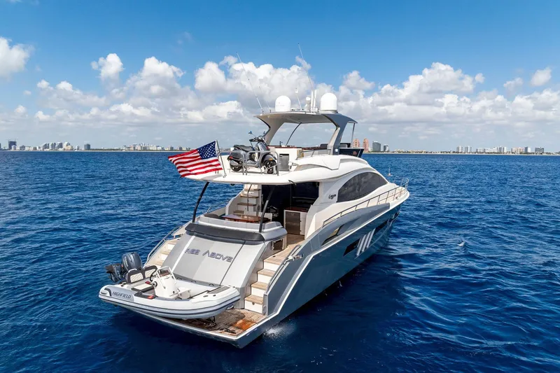 Slide: The Image of Luxurious 2014 Lazzara 64 yacht cruising on open ocean under clear skies. - 77