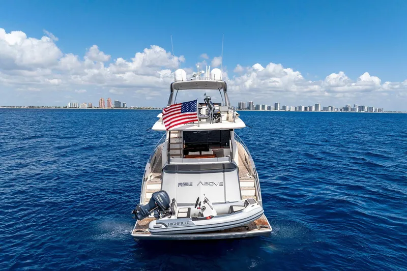 Slide: The Image of 2014 Lazzara 64 yacht cruising on blue ocean with city skyline in background. - 78
