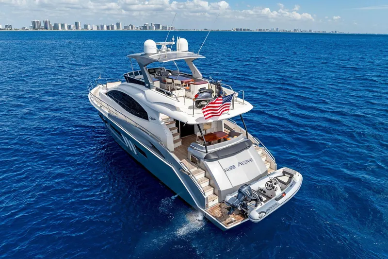 Slide: The Image of Luxurious 2014 Lazzara 64 yacht cruising on blue ocean near city skyline. - 80