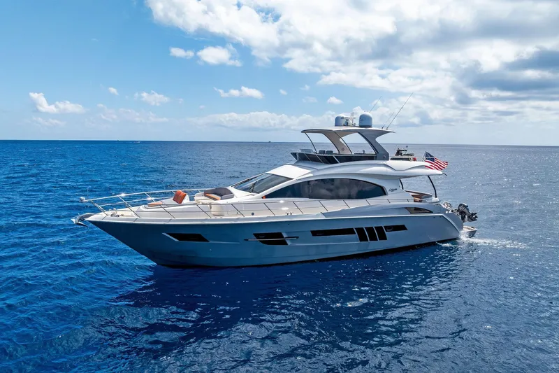 Slide: The Image of Luxury 2014 Lazzara 64 yacht cruising on open blue sea under cloudy sky. - 82