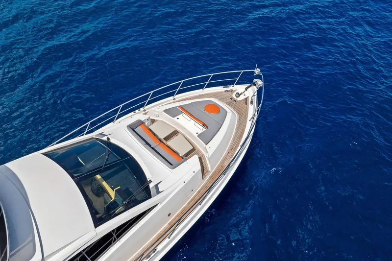 Slide: The Image of Aerial view of 2014 Lazzara 64 yacht cruising on deep blue ocean waters. - 83
