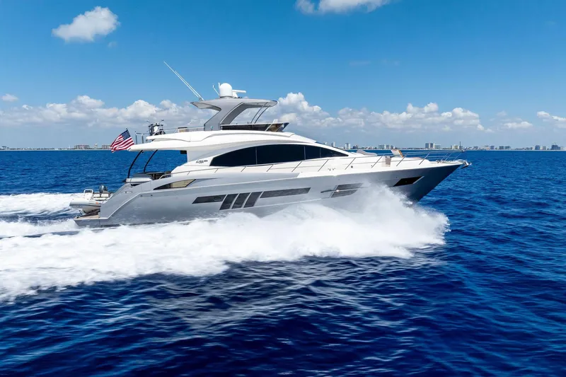 Slide: The Image of 2014 Lazzara 64 yacht cruising on open blue ocean under clear sky. - 85