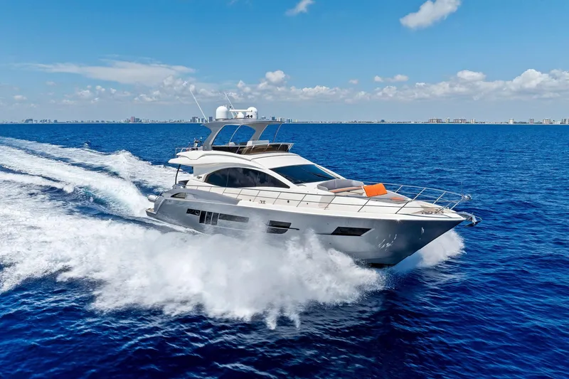 Slide: The Image of Luxurious 2014 Lazzara 64 yacht cruising swiftly on open blue ocean waters. - 86
