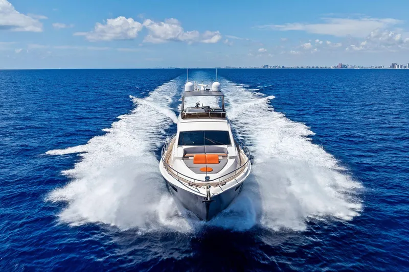 Slide: The Image of Luxurious 2014 Lazzara 64 yacht cruising on open blue ocean under clear skies. - 87