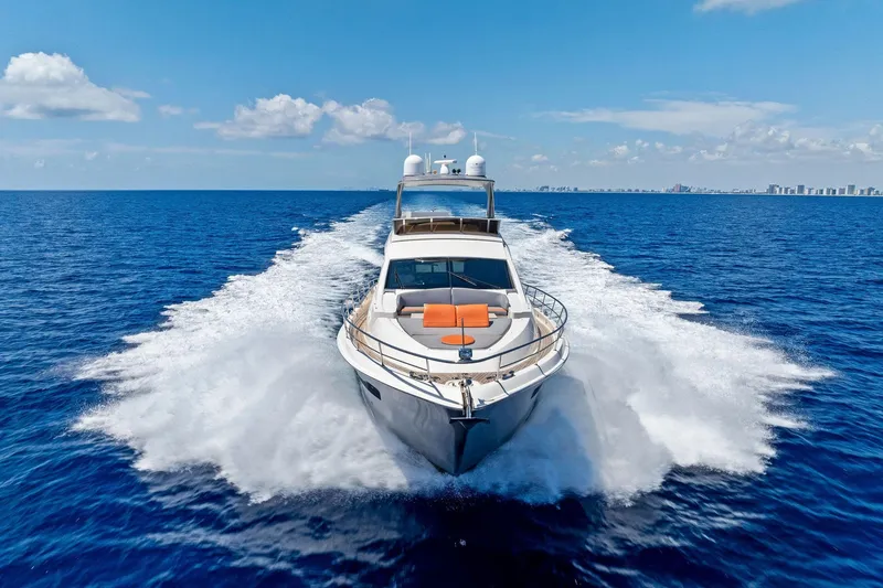 Slide: The Image of Luxurious 2014 Lazzara 64 yacht cruising on open ocean under clear blue sky. - 88