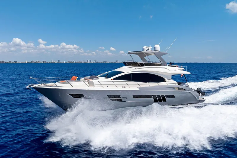 Slide: The Image of Luxury 2014 Lazzara 64 yacht cruising on open blue sea under clear sky. - 89
