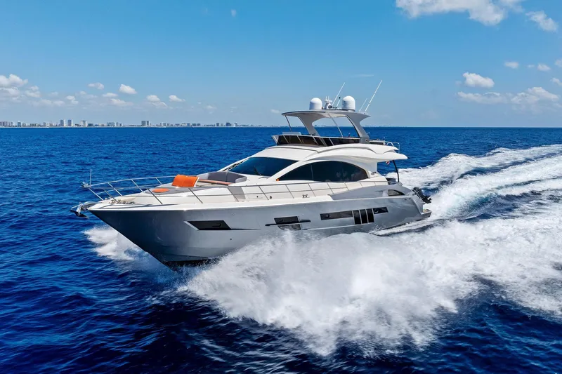 Slide: The Image of Luxury 2014 Lazzara 64 yacht cruising on open blue ocean under clear sky. - 90