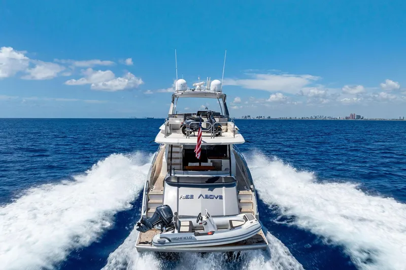 Slide: The Image of 2014 Lazzara 64 yacht cruising on open sea under clear blue sky. - 91