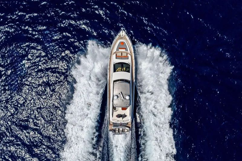 Slide: The Image of Aerial view of 2014 Lazzara 64 yacht cruising through deep blue ocean waters. - 92