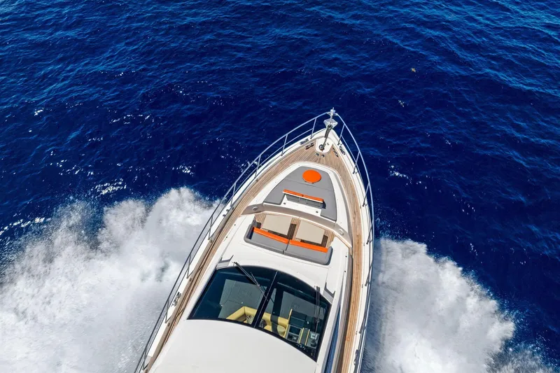 Slide: The Image of Aerial view of 2014 Lazzara 64 yacht cruising on deep blue ocean waters. - 93