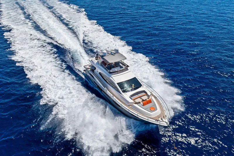 Slide: The Image of Luxurious 2014 Lazzara 64 yacht cruising swiftly on open blue ocean waters. - 94