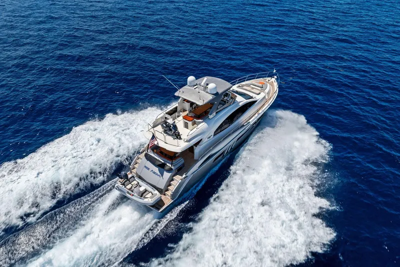 Slide: The Image of Luxurious 2014 Lazzara 64 yacht cruising on open blue sea, aerial view. - 95