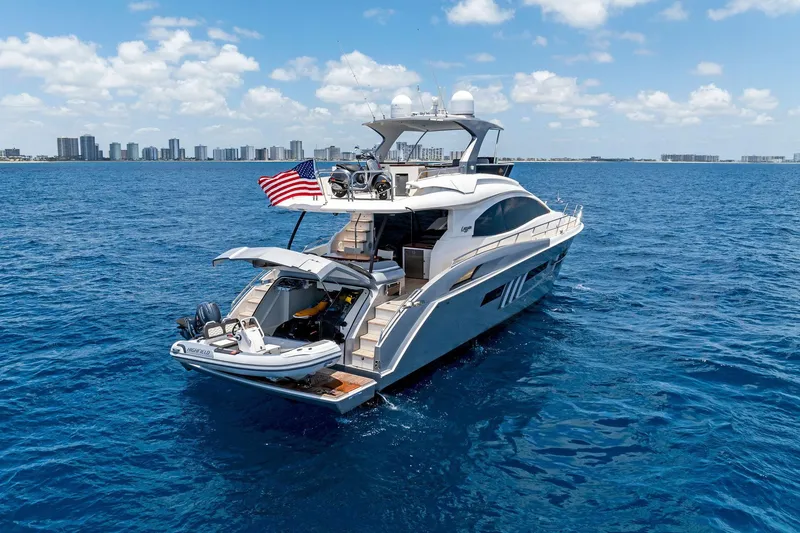 Slide: The Image of Luxury 2014 Lazzara 64 yacht cruising on blue ocean with city skyline in background. - 96