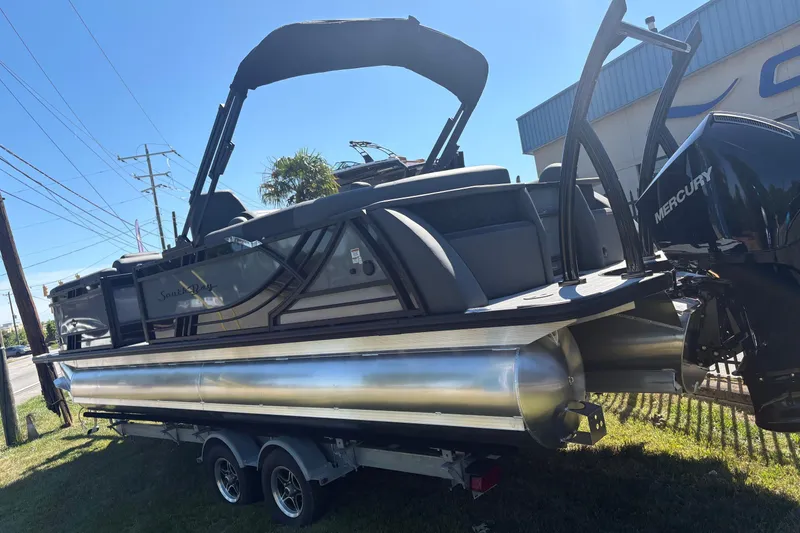 Slide: The Image of 2026 South Bay 525RS pontoon boat on trailer, featuring Mercury outboard motor. - 2