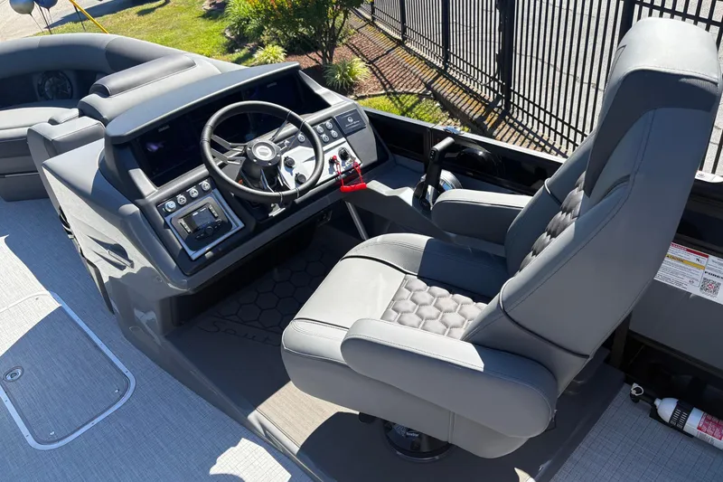 Slide: The Image of 2026 South Bay 525RS boat cockpit with modern steering and plush seating. - 7