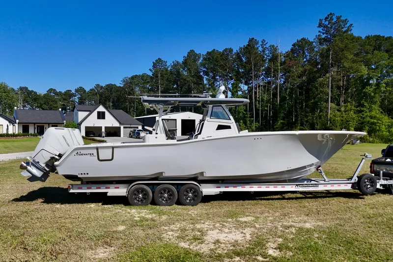 The Image of 2024 Tidewater 380 CC Adventure boat on trailer, parked outdoors. - 0