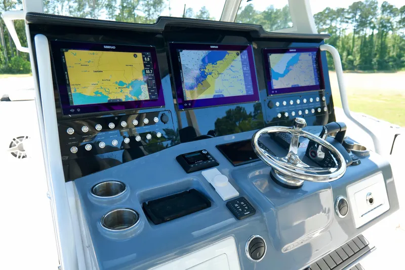 Slide: The Image of 2024 Tidewater 380 CC Adventure boat dashboard with advanced navigation displays and controls. - 14