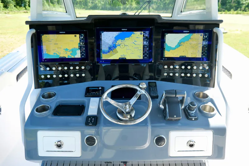 Slide: The Image of 2024 Tidewater 380 CC Adventure helm with advanced navigation displays and controls. - 15