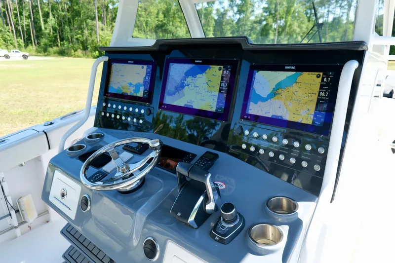 Slide: The Image of 2024 Tidewater 380 CC Adventure helm with advanced navigation displays and controls. - 16