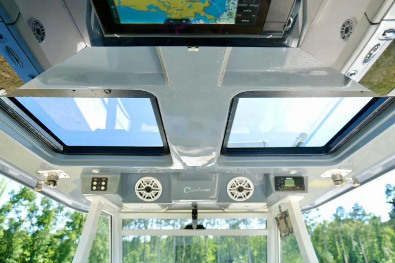 Slide: The Image of 2024 Tidewater 380 CC Adventure boat interior with skylight and electronic controls. - 17