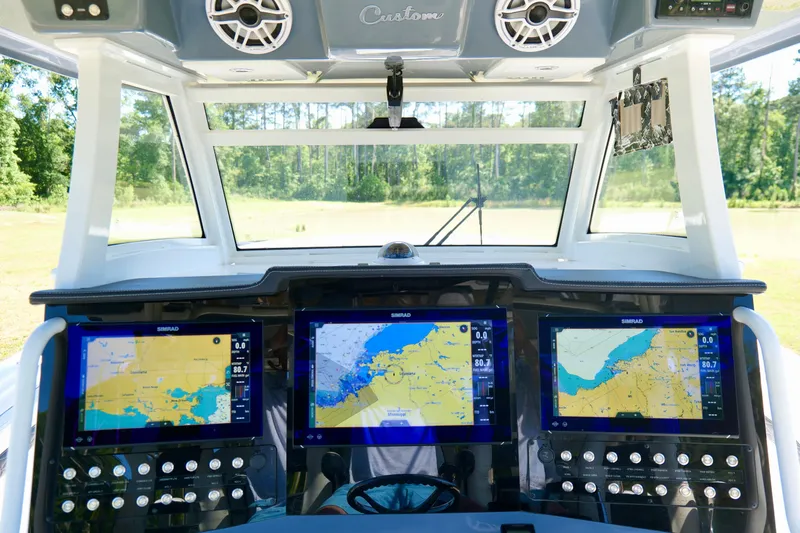 Slide: The Image of 2024 Tidewater 380 CC Adventure helm with advanced navigation displays and controls. - 18