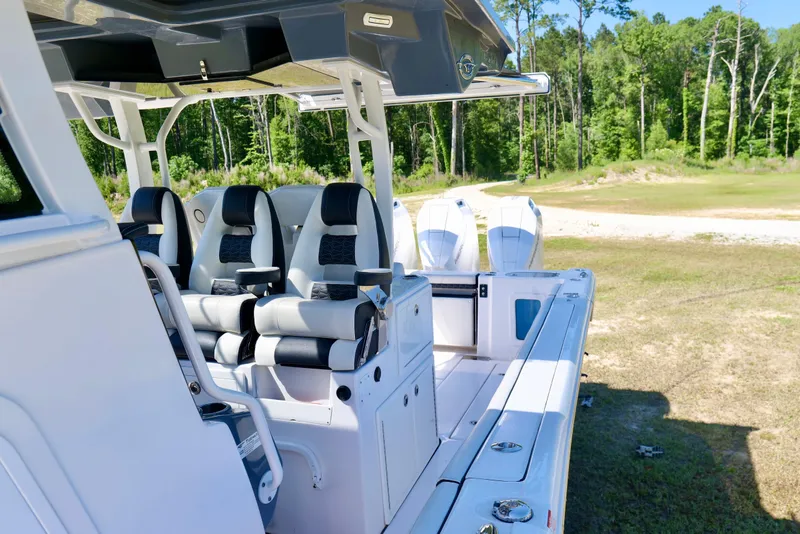 Slide: The Image of 2024 Tidewater 380 CC Adventure boat interior with seating and twin engines. - 21