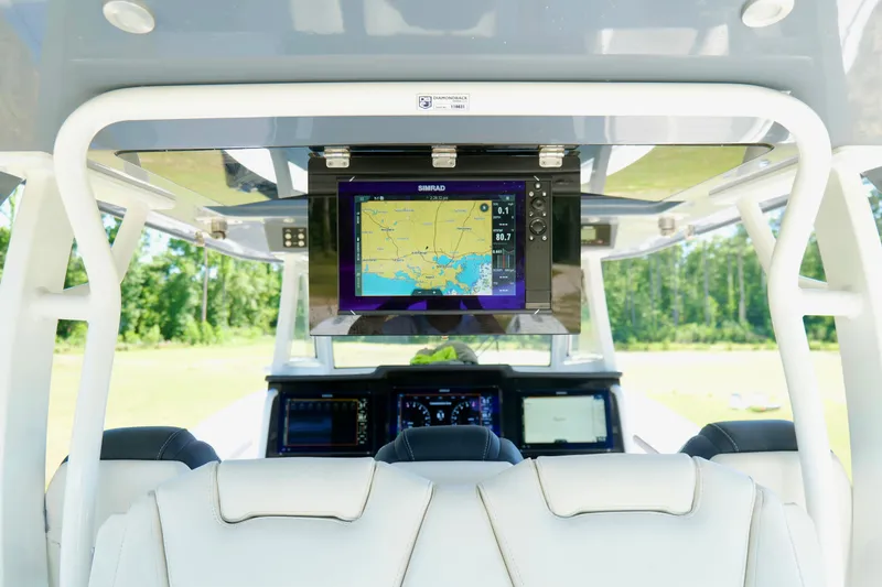 Slide: The Image of 2024 Tidewater 380 CC Adventure boat cockpit with navigation display and luxurious seating. - 23