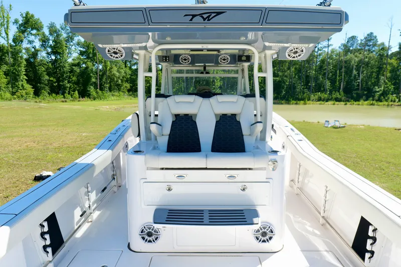Slide: The Image of 2024 Tidewater 380 CC Adventure boat interior with seating and speakers. - 24