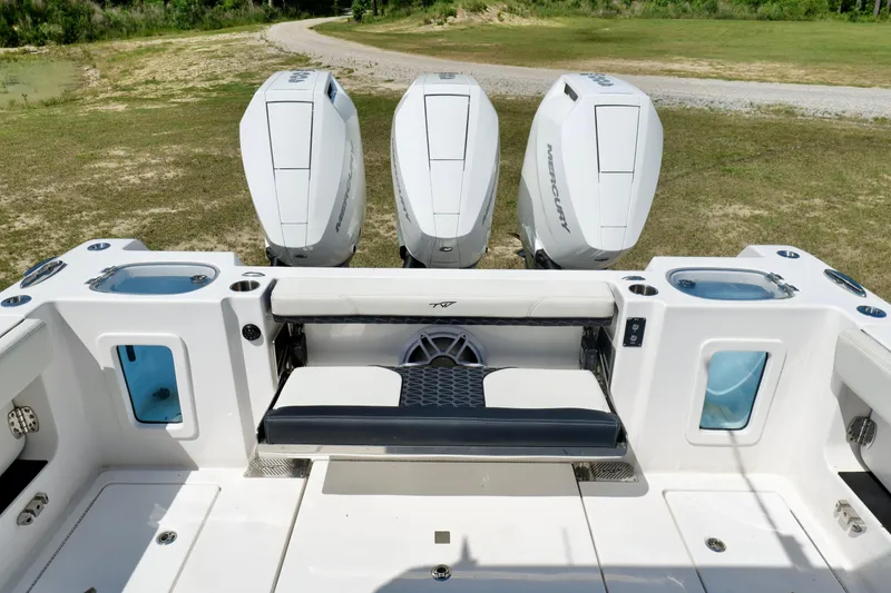 Slide: The Image of 2024 Tidewater 380 CC Adventure boat with triple Mercury outboard engines, featuring a spacious deck. - 4