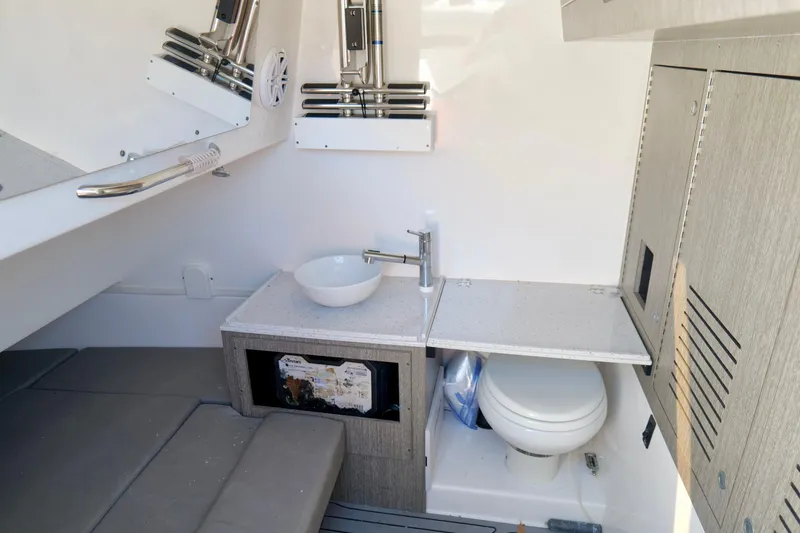Slide: The Image of 2024 Tidewater 380 CC Adventure cabin with sink, toilet, and storage cabinets. - 40