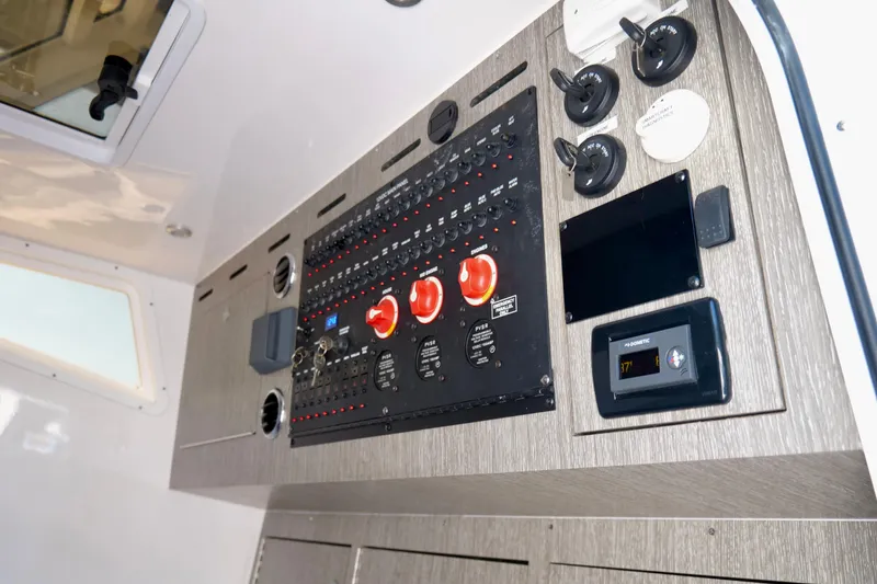 Slide: The Image of Control panel of 2024 Tidewater 380 CC Adventure boat, featuring switches and displays. - 42
