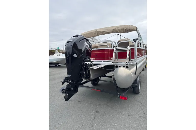 Slide: The Image of 2024 Sun Tracker Bass Buggy 18 DLX pontoon boat with outboard motor, rear view. - 3