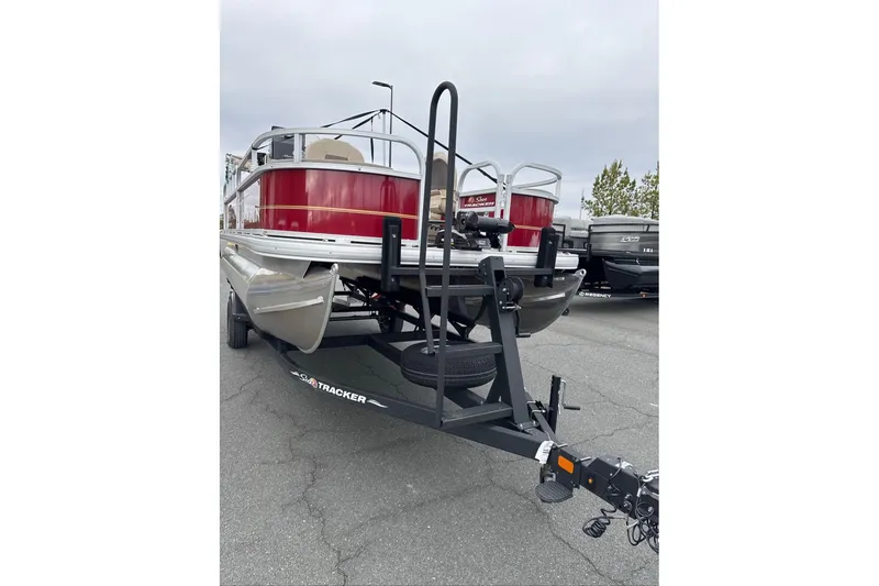 Slide: The Image of 2024 Sun Tracker Bass Buggy 18 DLX pontoon boat on trailer, rear view. - 4