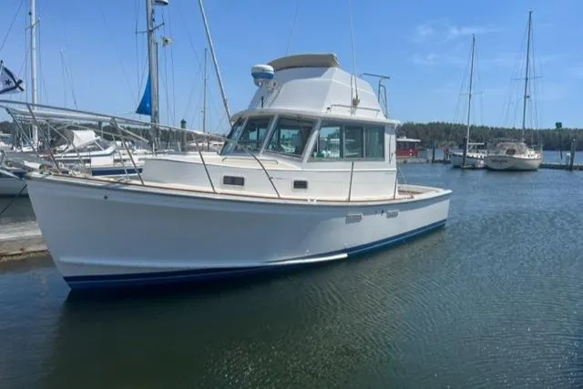 The Image of 1989 Cape Dory Flybridge Cruiser docked, blue and white yacht. - 0