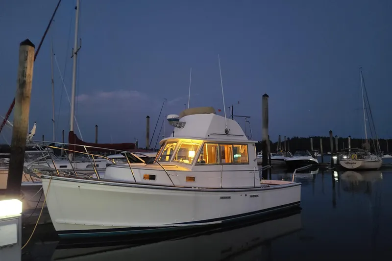 Slide: The Image of 1989 Cape Dory Flybridge Cruiser docked at dusk. - 1