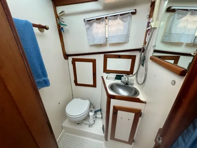 Slide: The Image of Bathroom in 1989 Cape Dory Flybridge Cruiser with sink and toilet. - 12